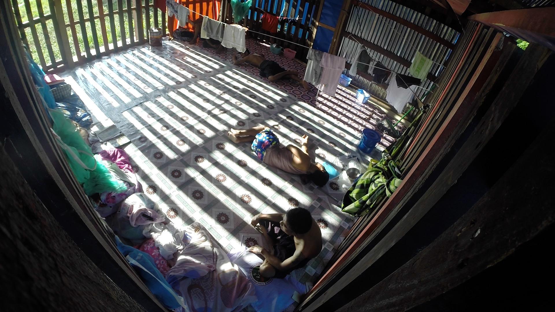 Drug addicts suffering severe withdrawal pains are locked in a barred cell at Rebirth Rehabilitation Center in Myitkyina. These room-sized cages, common at rehab camps in Myanmar's north, prevent addicts from escaping to score more drugs. The Christian-ru