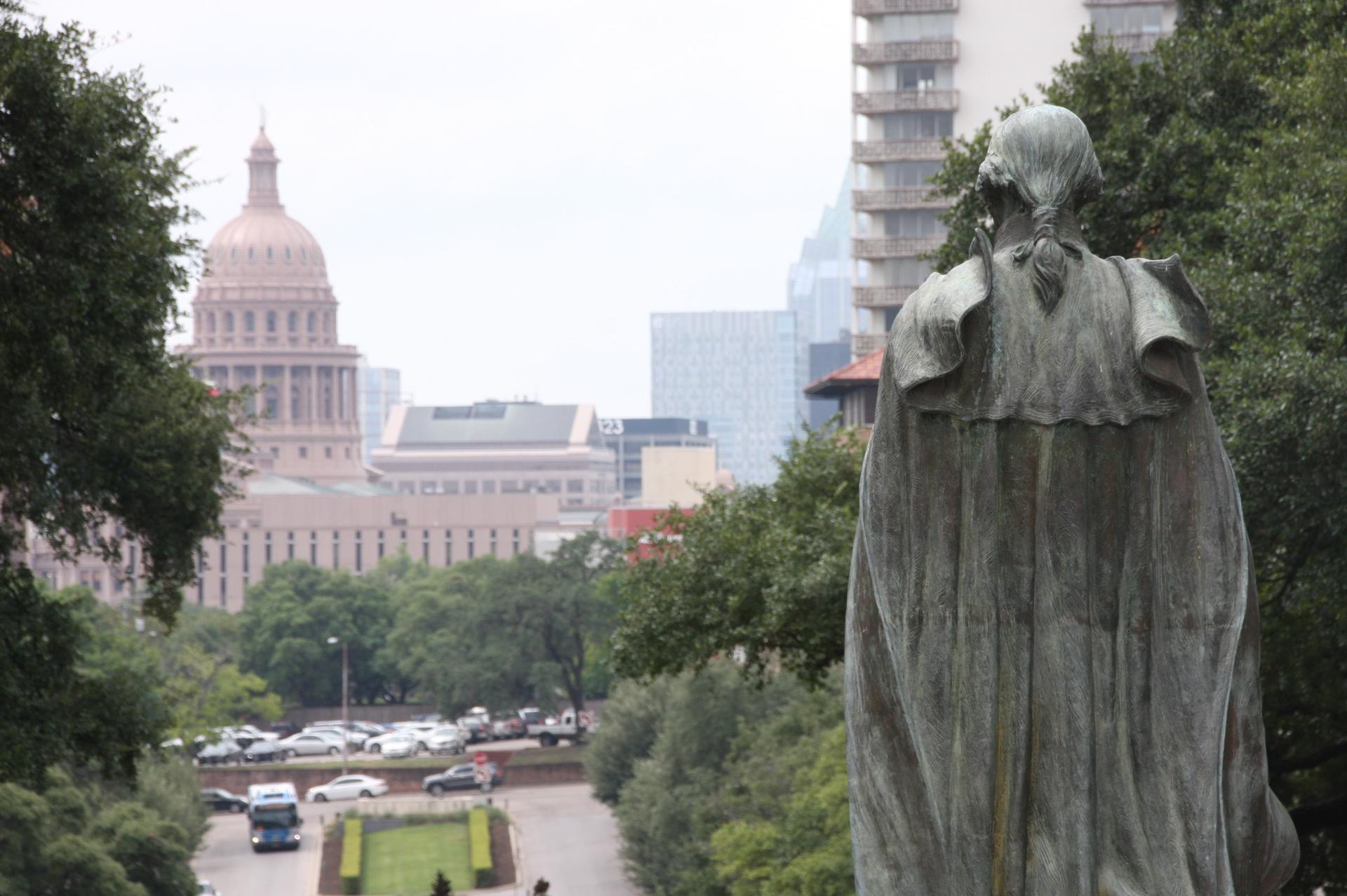 George Washington, the only statue left standing on the South Mall at the University of Texas at Austin, looks toward the Texas Capitol building.