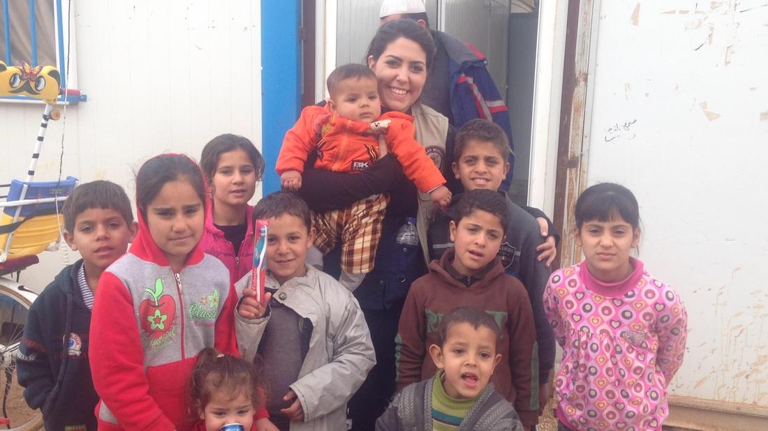 Amal with Zaatari children after distributing tooth brushes snd toothpaste.