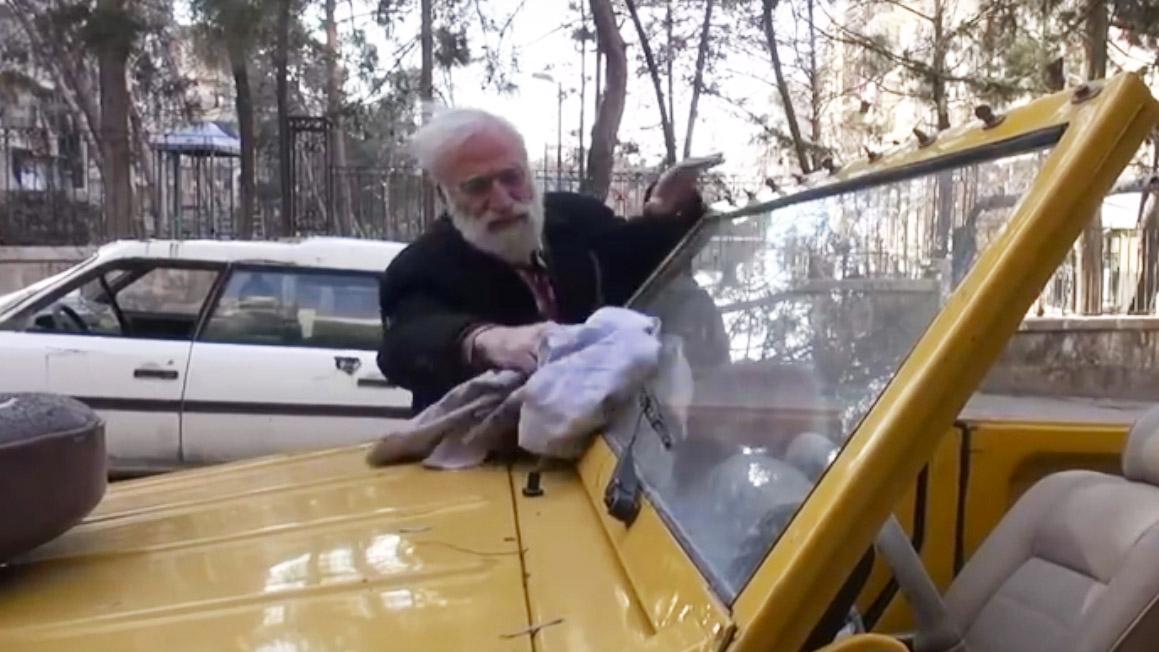 Abu Omar cleans one of his vintage vehicles in Aleppo, Syria.