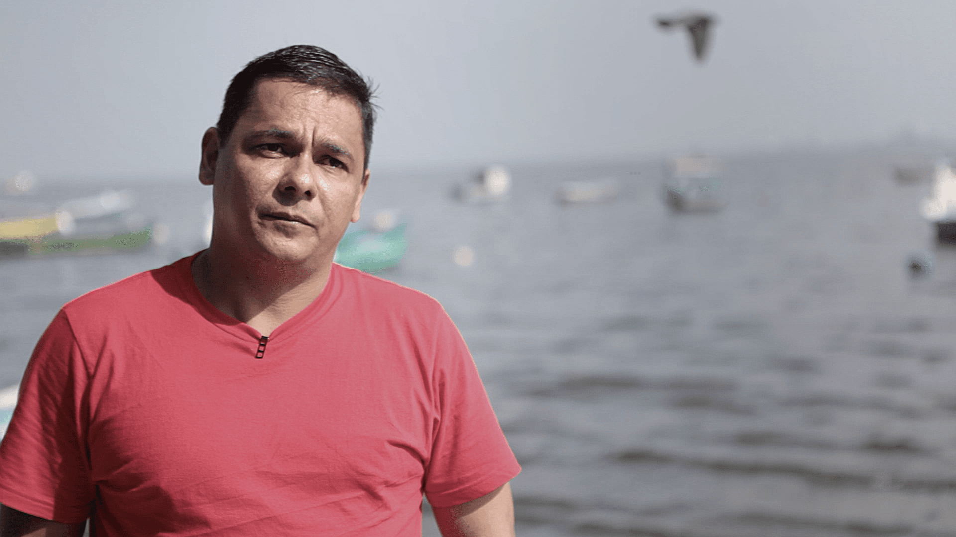 43-year-old fisherman-turned-activist Sandy Anderson stands on the shore of Brazil's Guarabana Bay, just outside Rio de Janeiro. Anderson says he's nearly been killed twice fighting to save this bay from polluters, and now lives in hiding.