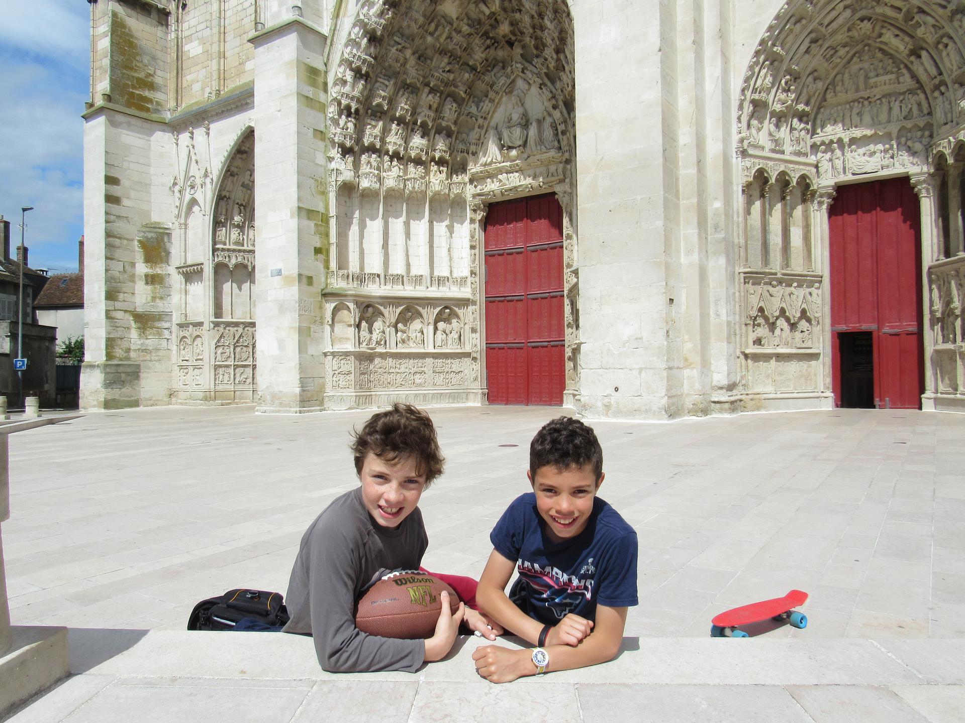 Author's children, Felix and Victor Delaney Sire, who play football at the foot of the cathedral in Auxerre