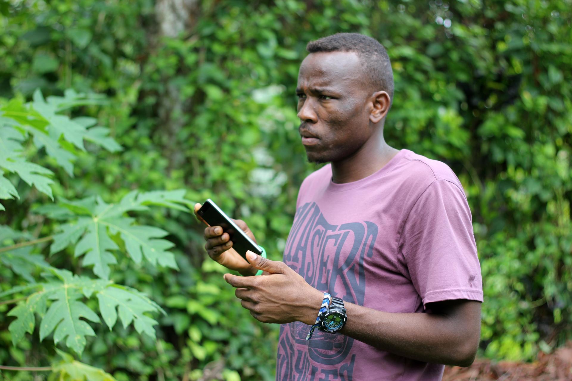 Aziz with his smart phone at the Manus Island detention camp on Papua New Guinea. The smart phone is his link to the outside world and how he sends WhatsApp audio messages to Michael Green.