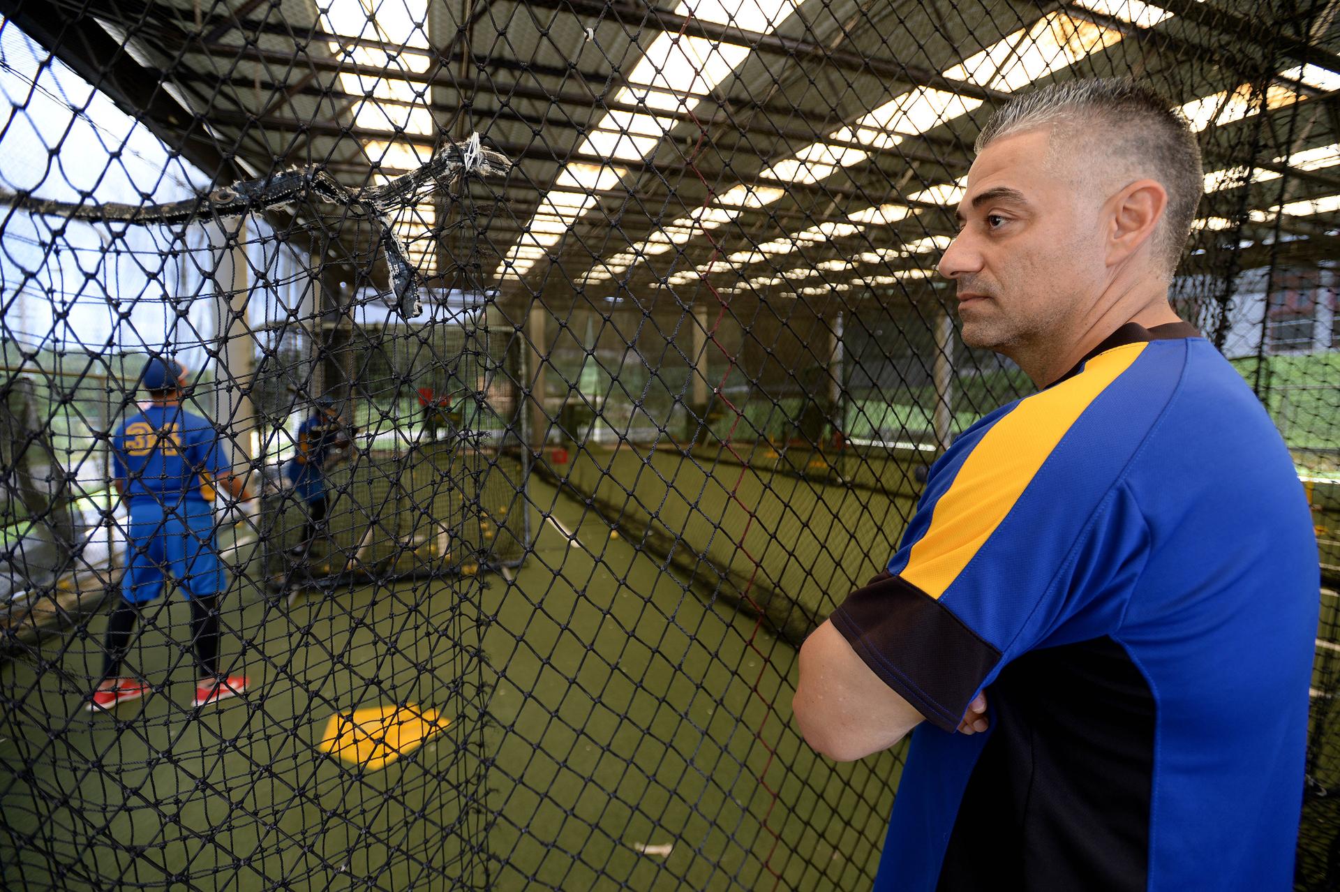 Former Major Leaguer Alex Diaz watches his players in the batting cages. Diaz now runs the athletic department at the Beltran Academy.