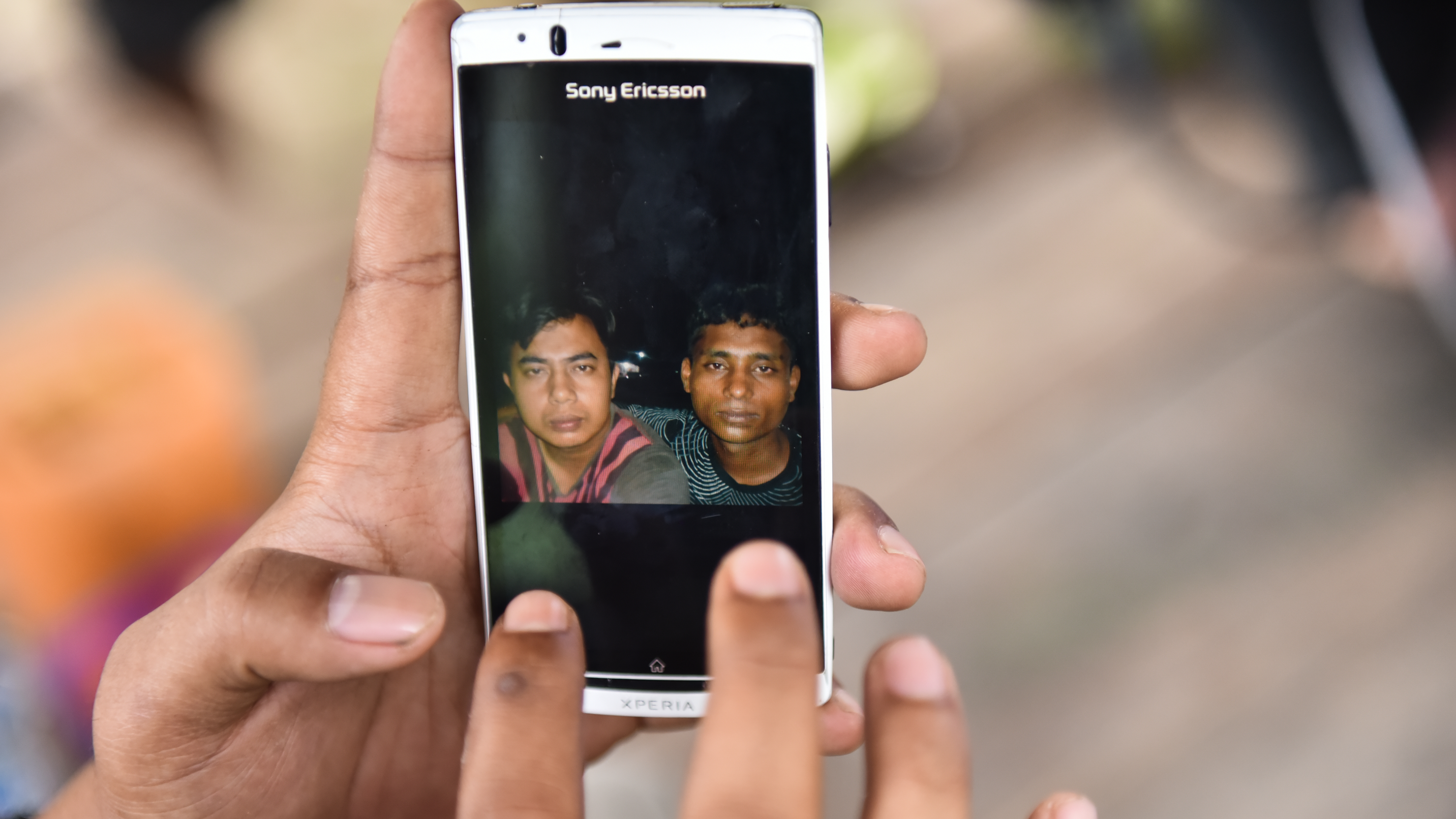 Fardan Rezeky shows pictures on his phone of friends he’s made in the Rohingya and Bangladeshi refugee camp in Bayeun, on July 19, 2015. Rezeky was there in May when the refugees arrived. He felt a call to help them, as many other countries helped Aceh af