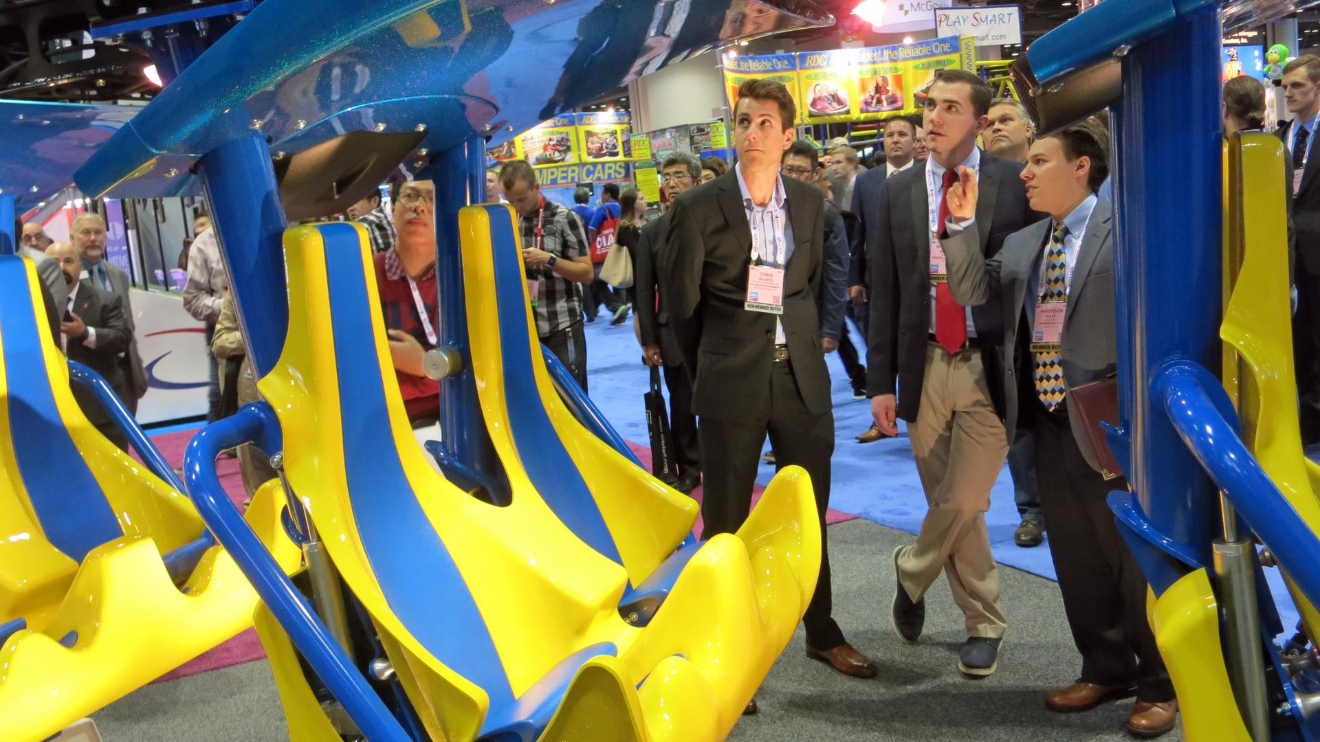 Park operators inspect the latest roller coaster designs at the IAAPA Expo in Orlando.