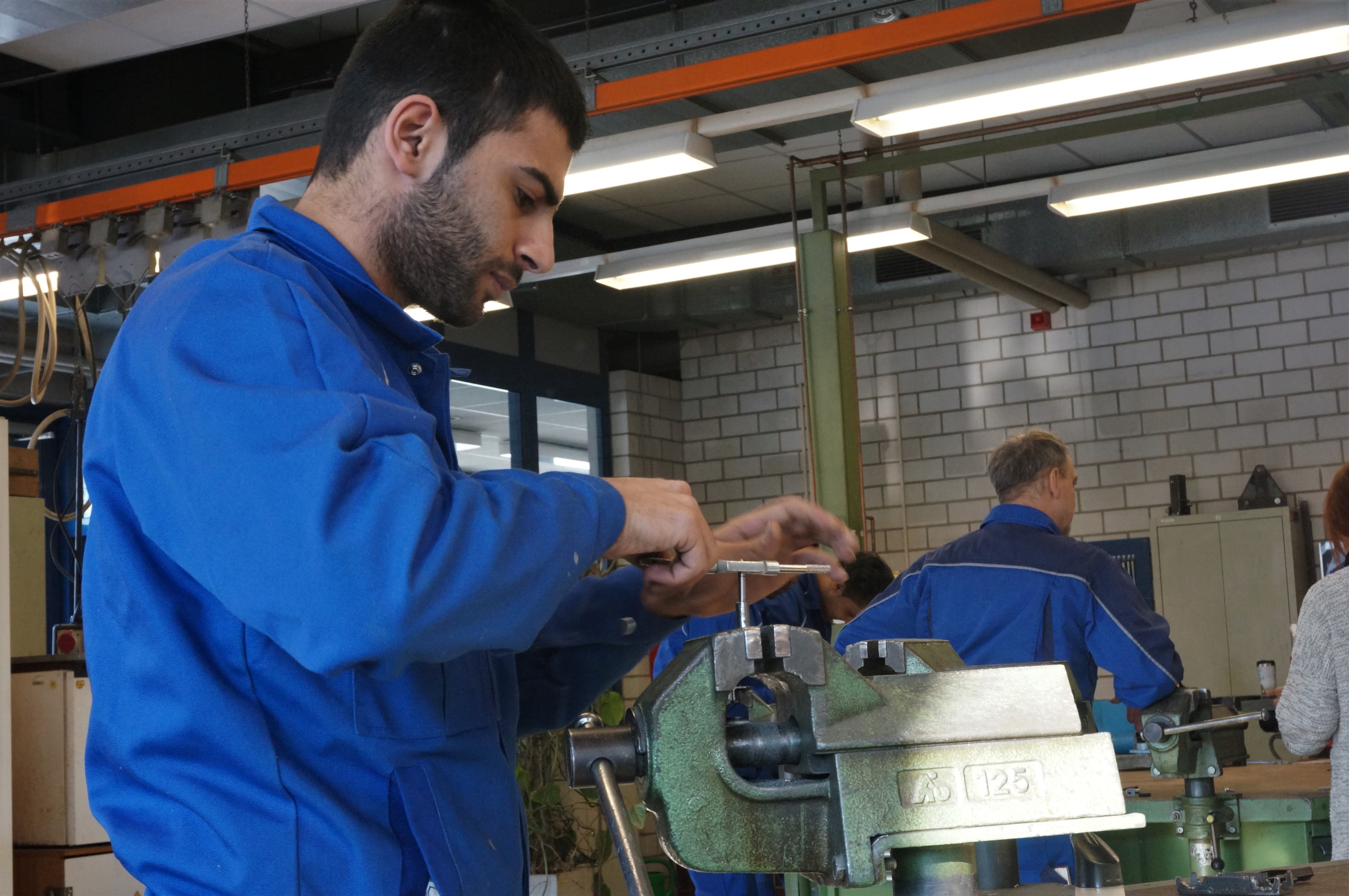 Ibrahim, 22, from Syria, works on the day's assignment at the Cottbus Chamber of Crafts, in Cottbus, Brandenburg, Germany, Jan. 11, 2017.