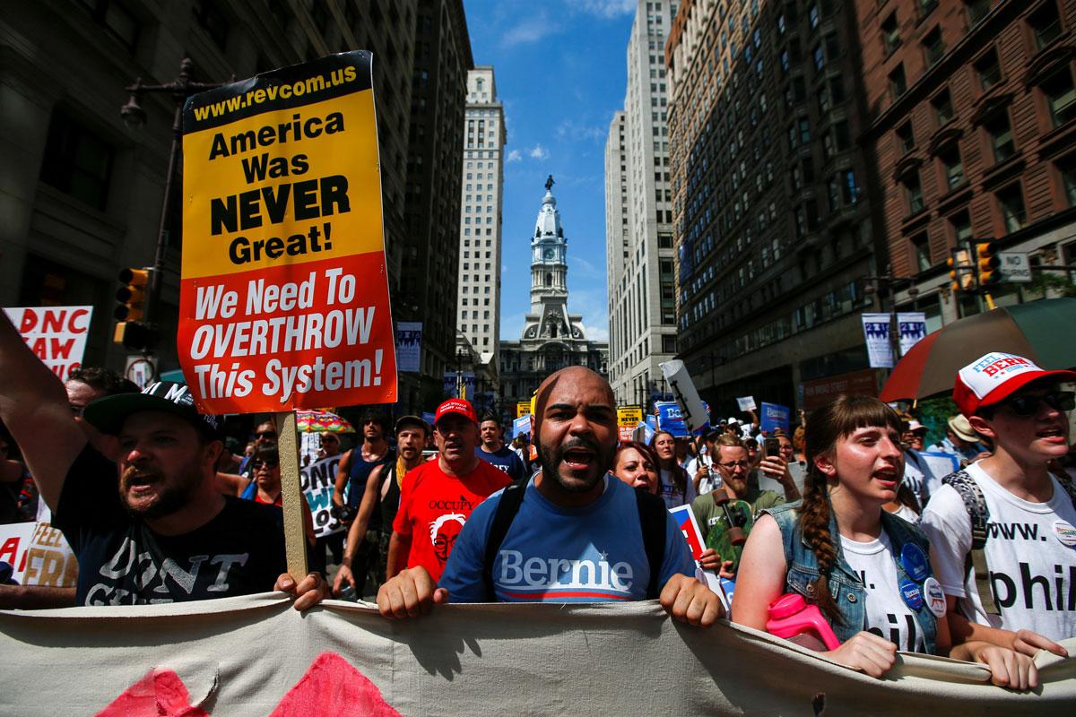 Philadelphia City Hall is seen in the background as supporters of Bernie Sanders take part in a protest march ahead of the DNC.