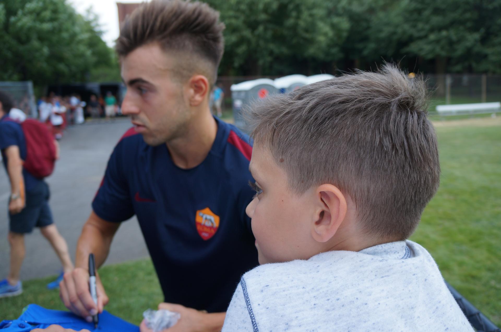 AS Roma’s Stephan El Shaarawy gives out signatures and poses for photos as a young fan looks on. This boy called out to El Shaarawy yelling ‘El!’ El!’ at the top of his lungs. After he got his signature he was very hapy.