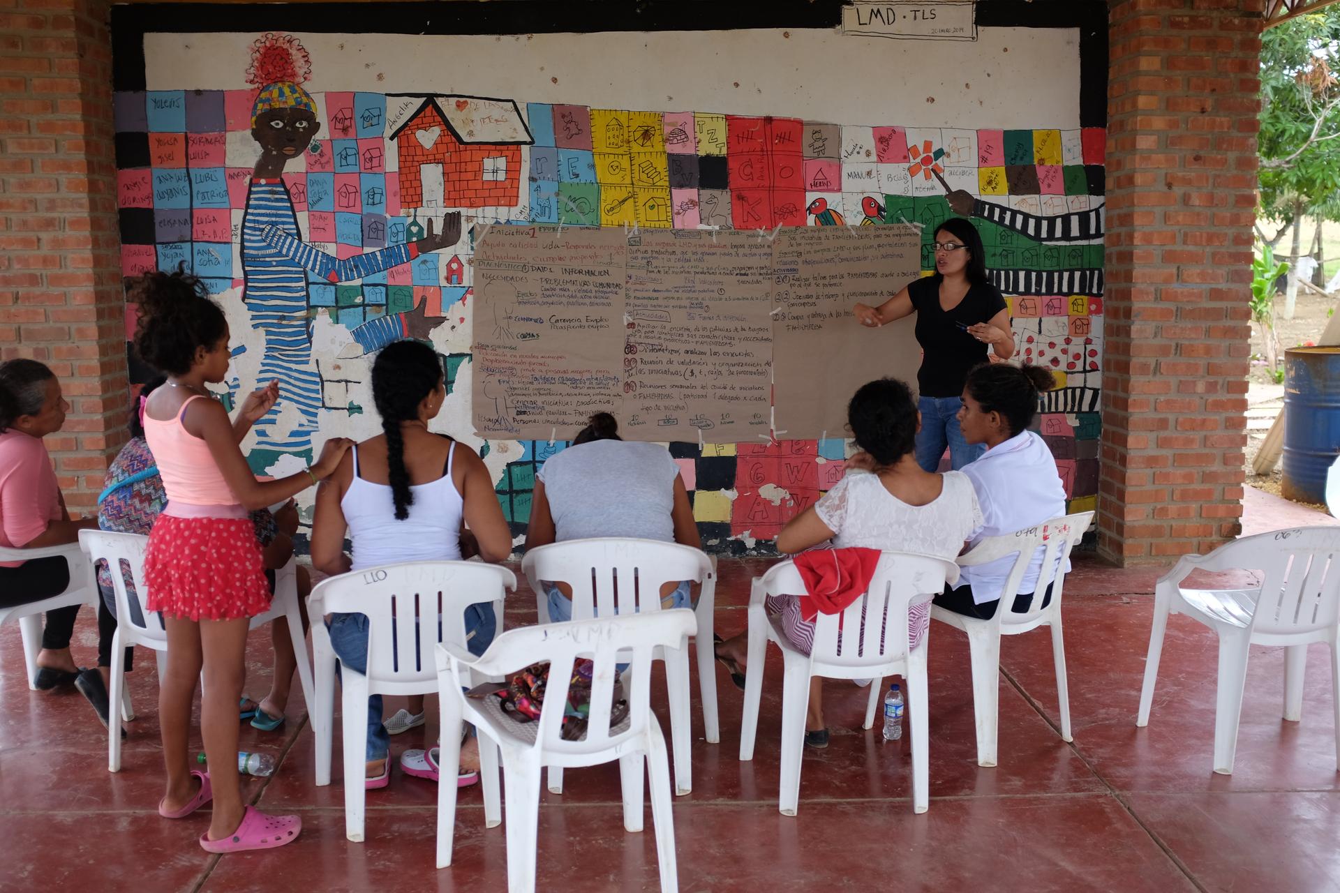 Residents of the City of Women attend a workshop at the community center.