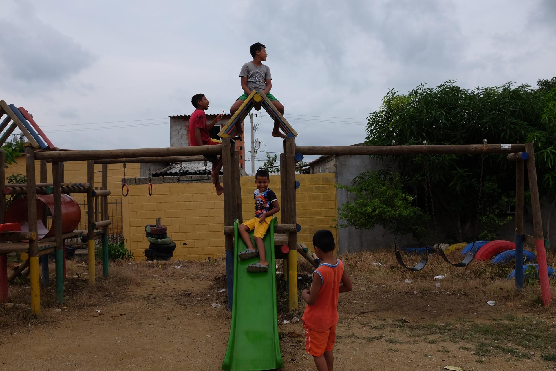 Children play on a playground in the City of Women.