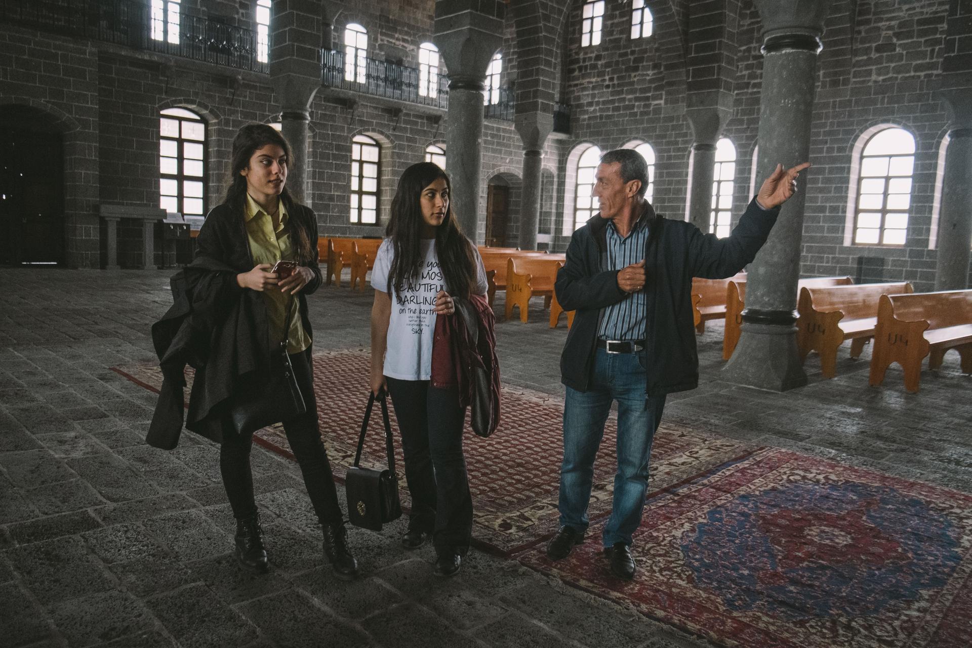 Ermen Demircian, caretaker of the Surp Giragos Armenian church in Diyarbakir, guides visitors during the lead up to the centennial memorial of the genocide.