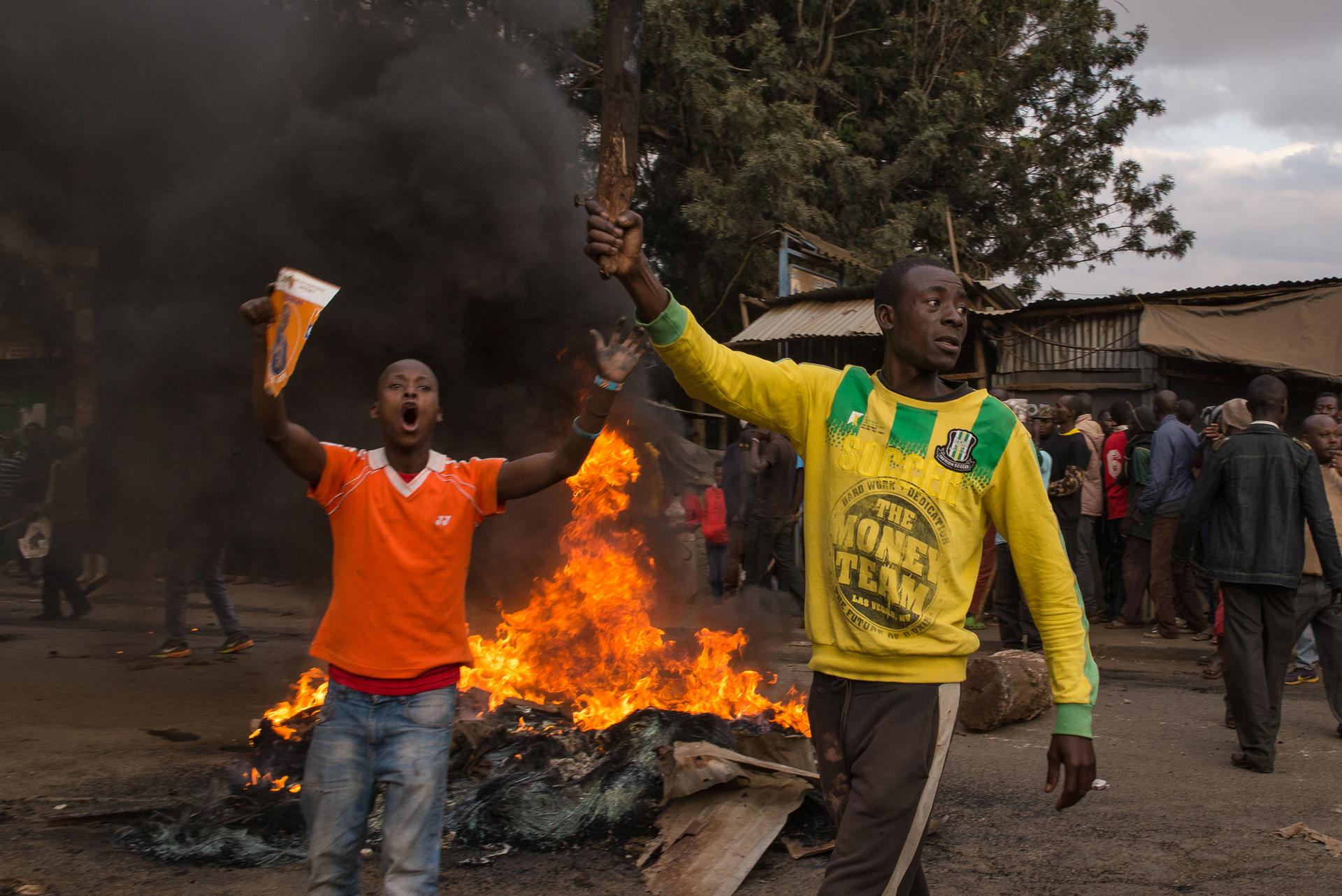 Men holding stones demand current President Uhuru Kenyatta step down from office. The demonstration came one day after Kenyans went to the polls to elect their next president.