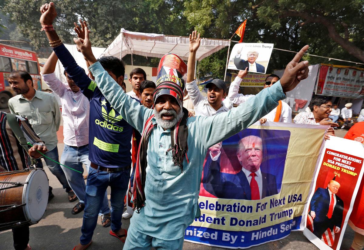 Members of Hindu Sena, a right-wing Hindu group, celebrate Donald Trump's victory in the US election, in New Delhi.