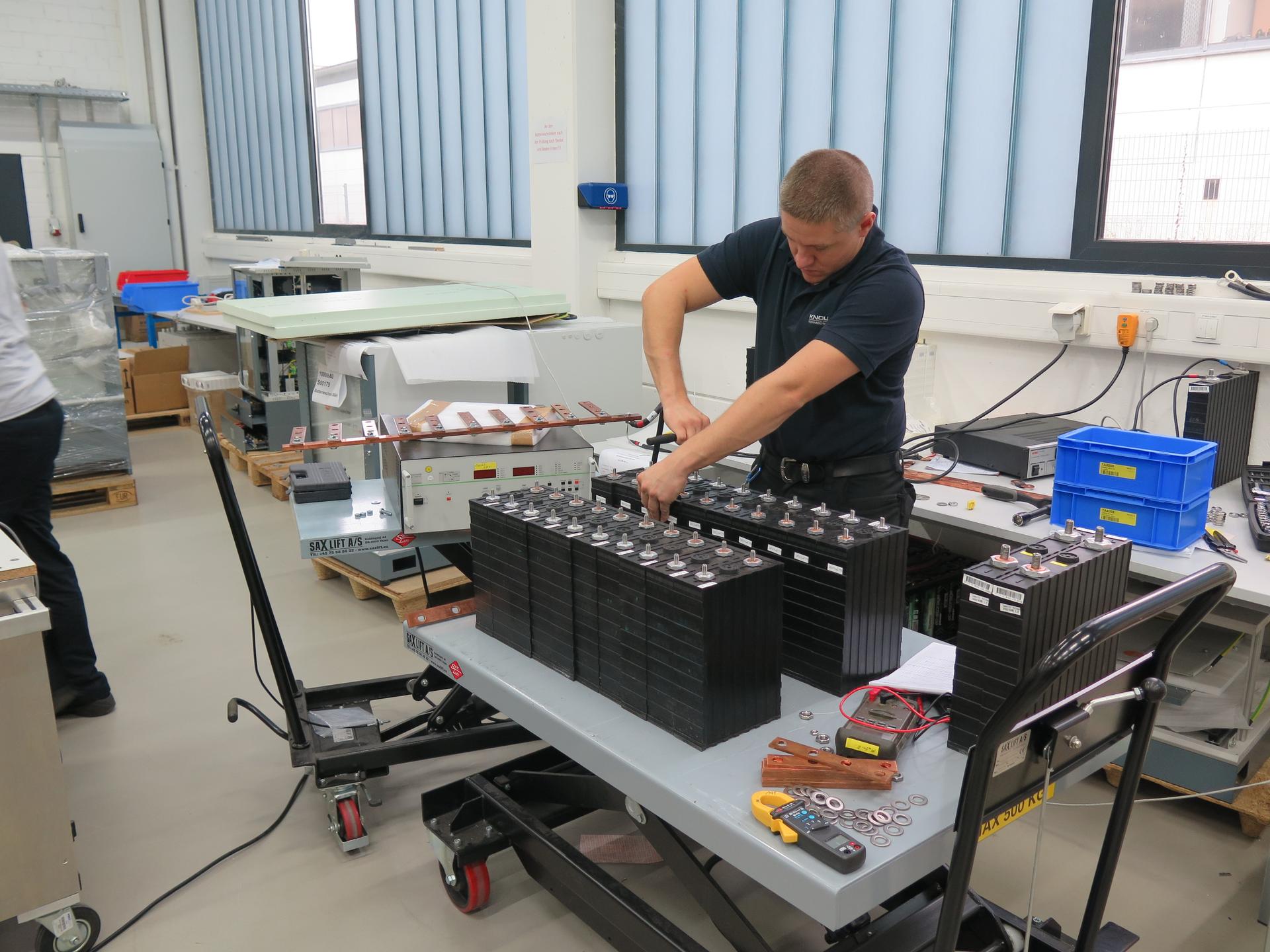 A technician checks a bank of lithium-iron-phosphate batteries for installation in a Sonnenspeicher system at he ASD factory in Umkirch, Germany. Wolfram Walter says his company's specially-designed electronics and software overcomes many of the limitatio
