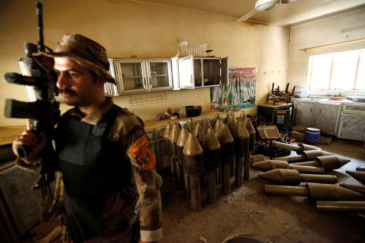 A member of the Iraqi counterterrorism forces stands by a former ISIS weapons factory in Fallujah.