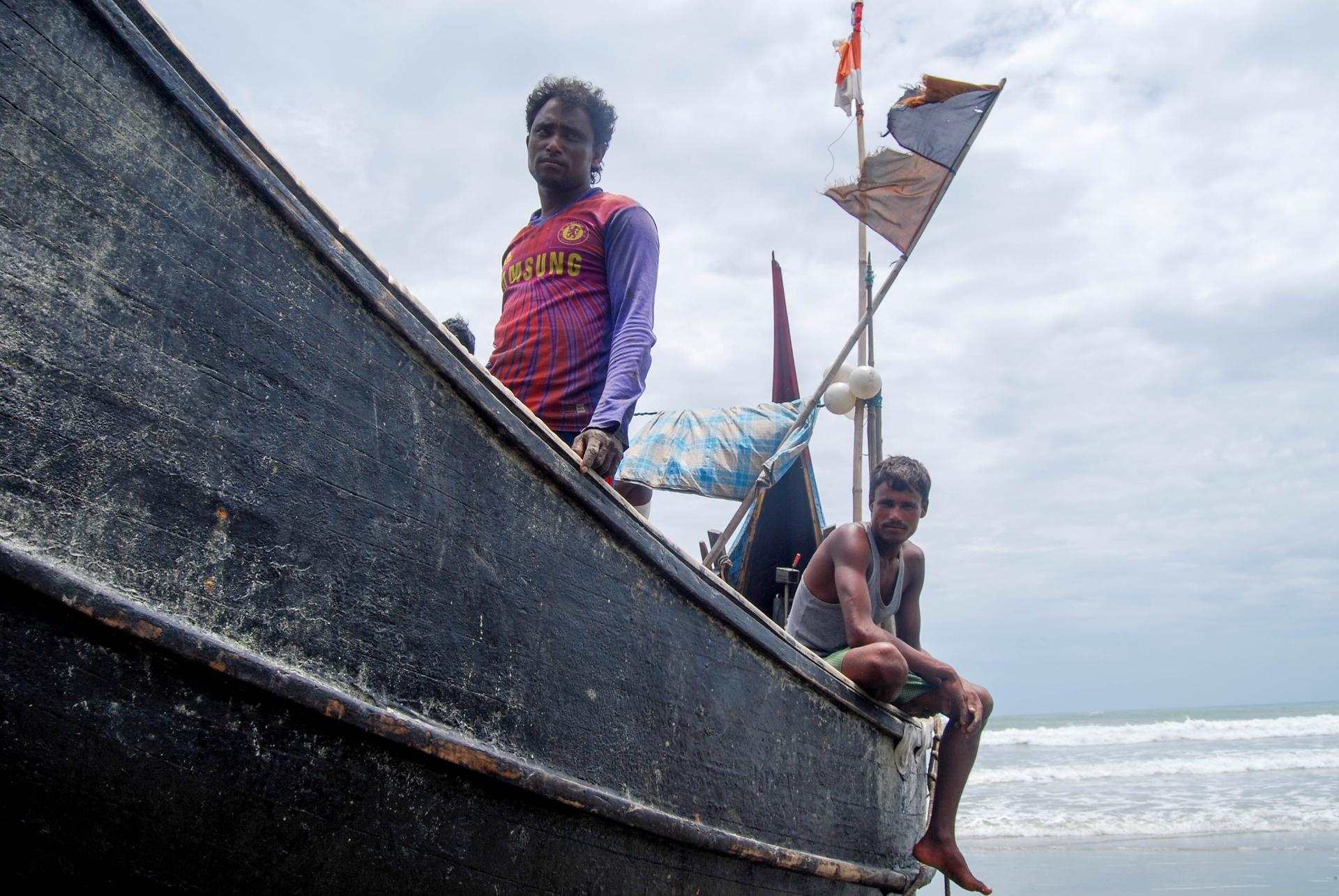 Aman Ullah, left, a Rohingya refugee in Cox's Bazar, takes home one-tenth of the profits that his fishing boat makes every day. The rest goes to the boat's owner and his four other crewmates.