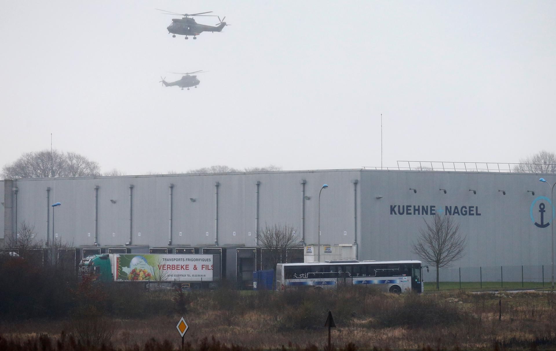 Helicopters with French intervention forces hover above the scene of a hostage taking at an industrial zone in Dammartin-en-Goele.