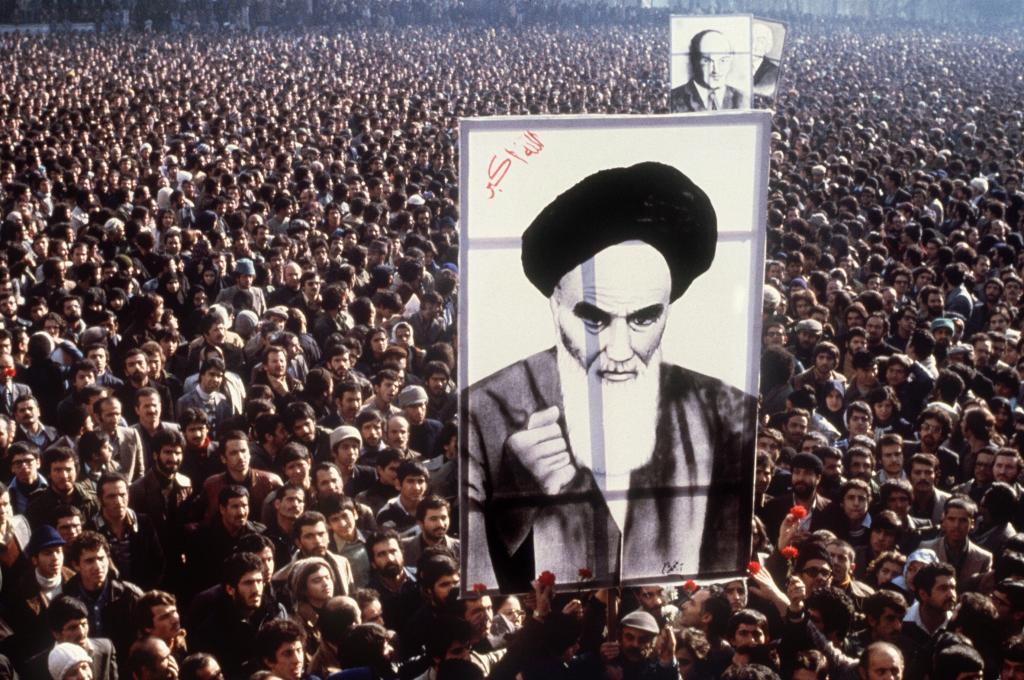 In a file picture taken in January 1979, Iranian protesters hold up a poster of Ayatollah Ruhollah Khomeini during a demonstration in Tehran against the Shah. Weeks later, the US-backed leader was toppled. Months later, the Islamic Revolution in Iran was