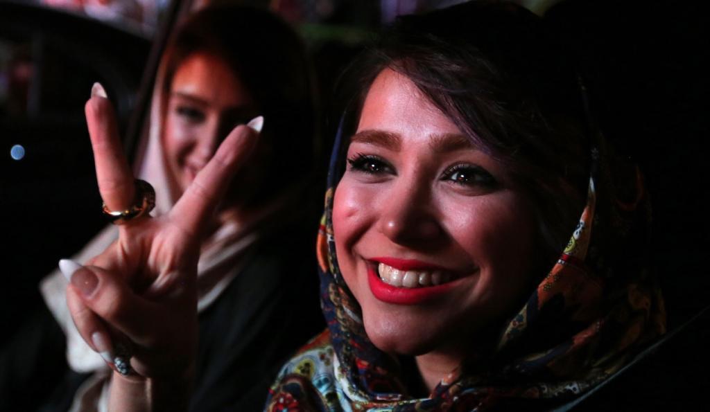 Iranian women flash the 'V' sign for victory during celebrations in northern Tehran on July 14, 2015, after Iran's nuclear negotiating team struck a deal with world powers in Vienna.
