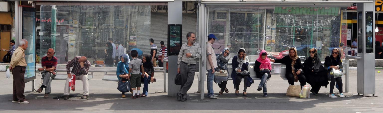 Iranians sit at a bus station in Tehran on July 16, 2015.