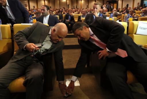 German Economy and Energy Minister Sigmar Gabriel (R) and Iranian Oil Minister Bijan Namdar Zanganeh (L) fall all over each other at Iran's Chamber of Commerce in Tehran on July 20, 2015, days after the nuclear accord was struck.