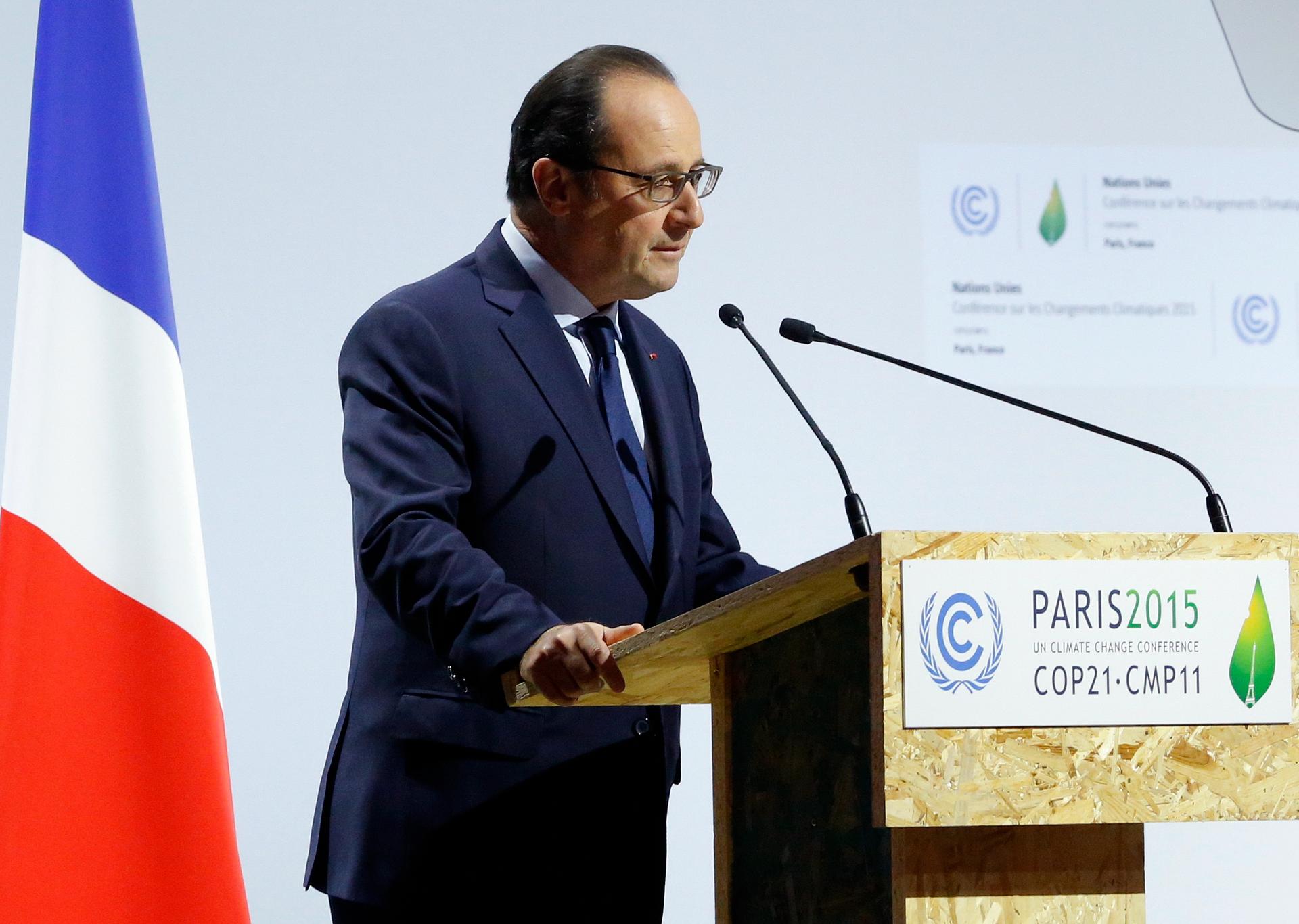 French President Francois Hollande speaks on the opening day of the 2015 World Climate Change Conference in Paris, less than three weeks after a string of attacks in the city killed at least 130 people. 