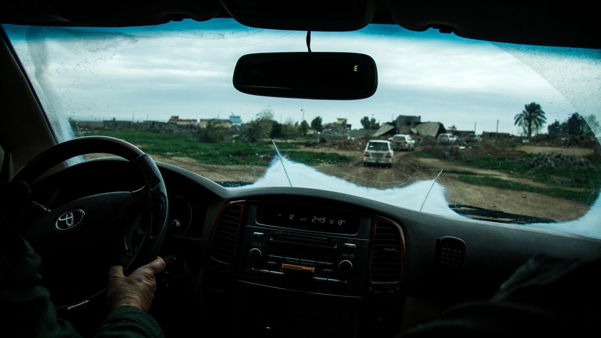 The village of Kharabaroot, near Kirkuk, seen through the windshield of a Peshmerga pickup truck.