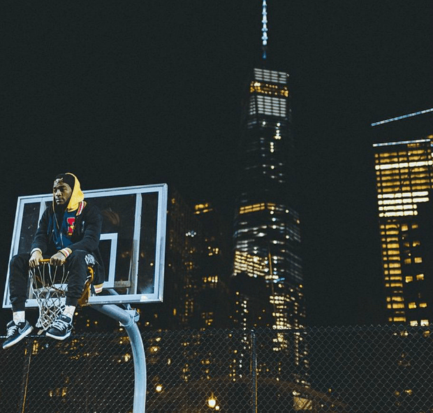 A photo of one of Humza's friends on a basketball hoop, with 1 World Trade Center in the background.