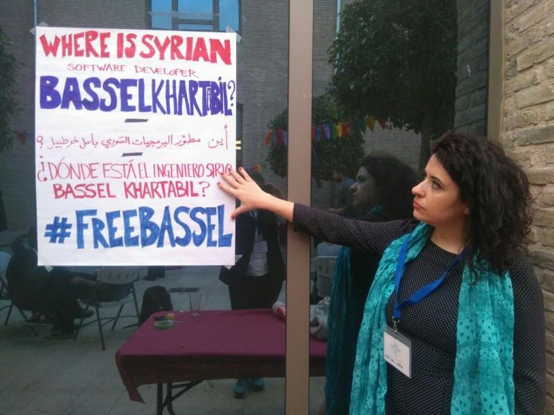 Rego points to a poster appealing for the freedom of Syrian software developer Bassel Khartabil.