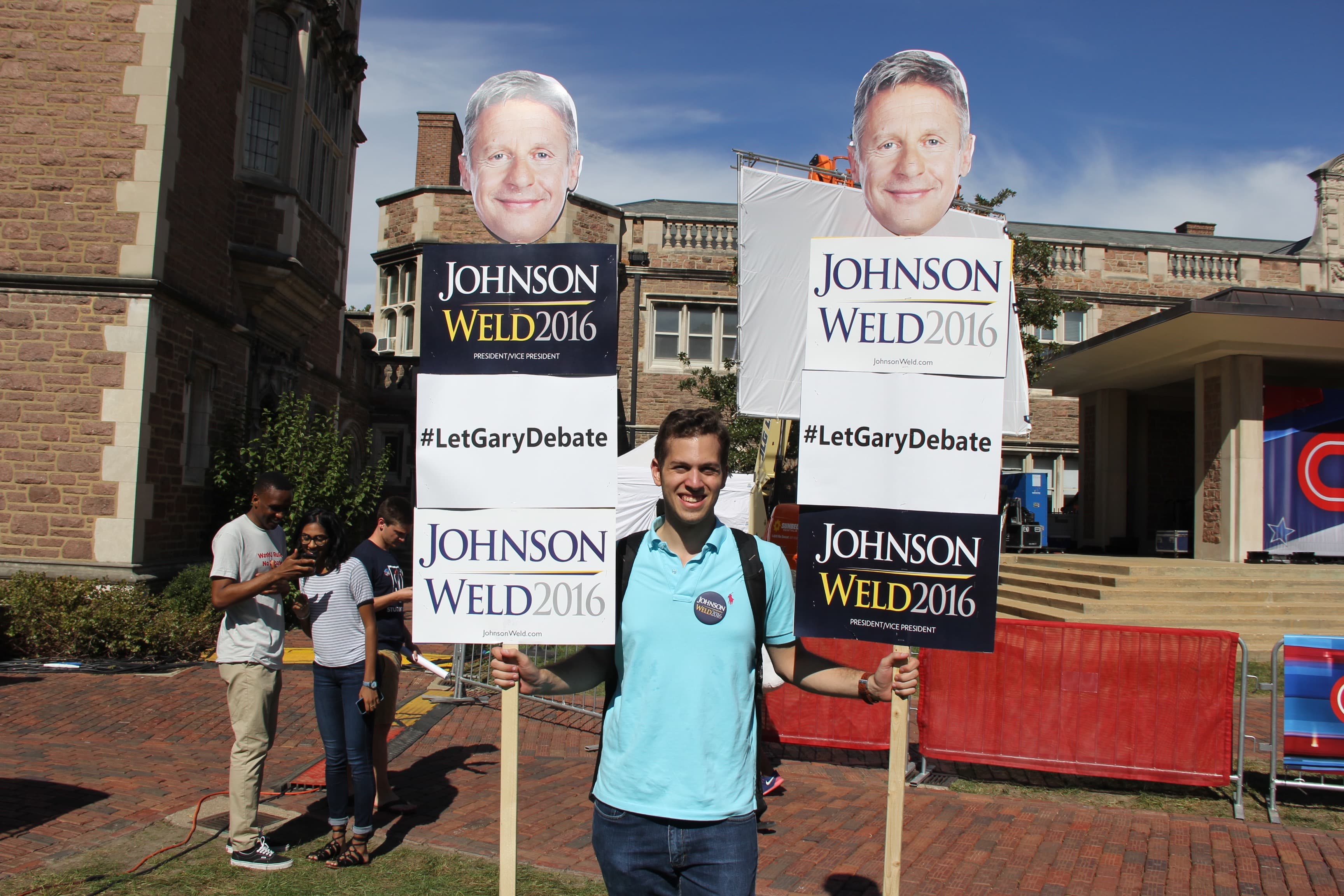 Student holding #LetGaryDebate sign