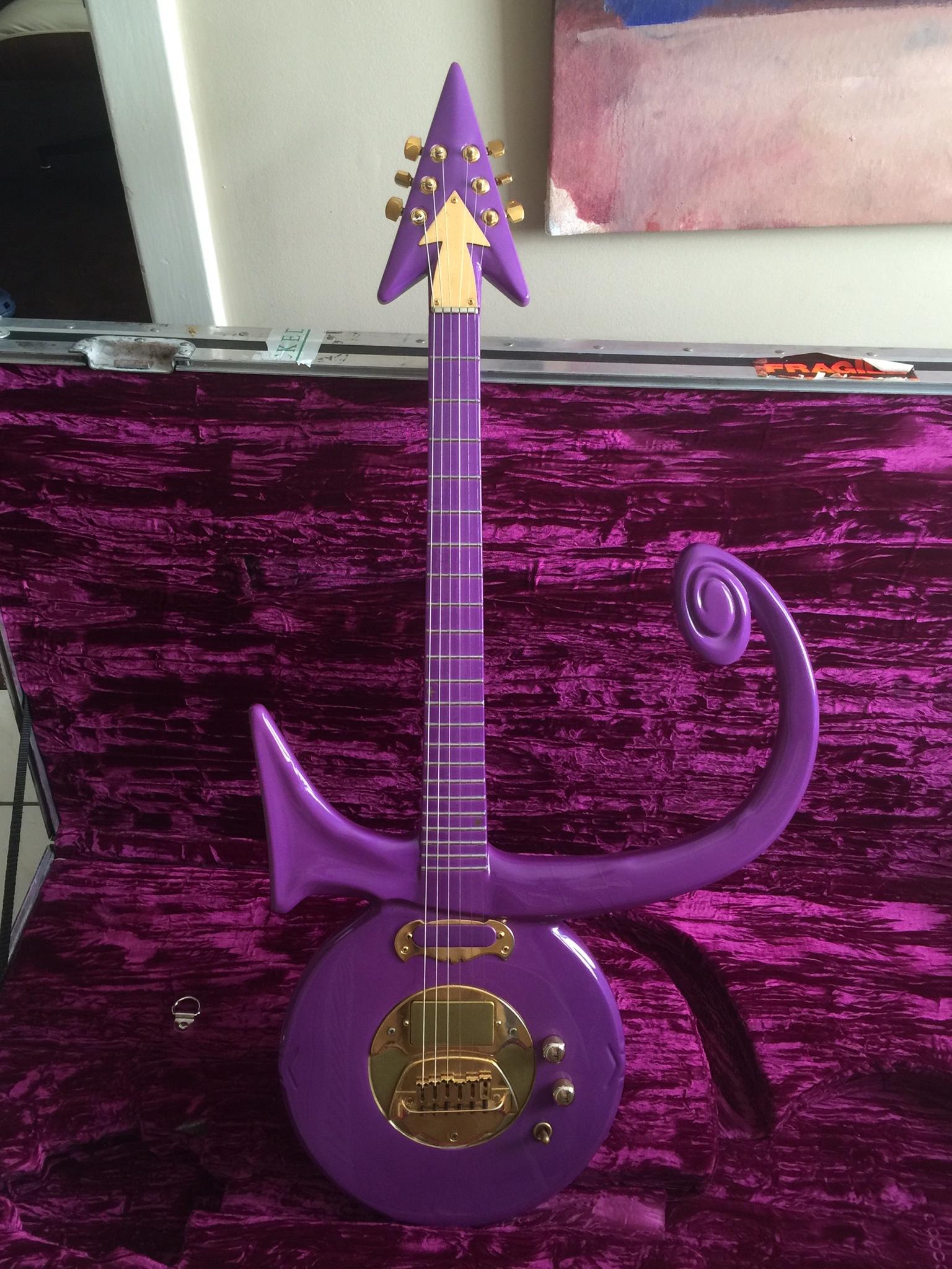 A purple guitar in the shape of 