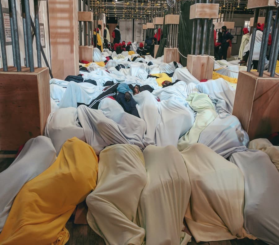 Hundreds of people rescued in the Mediterranean Sea are wrapped in blankets and resting in all corners of Save the Children's ship.