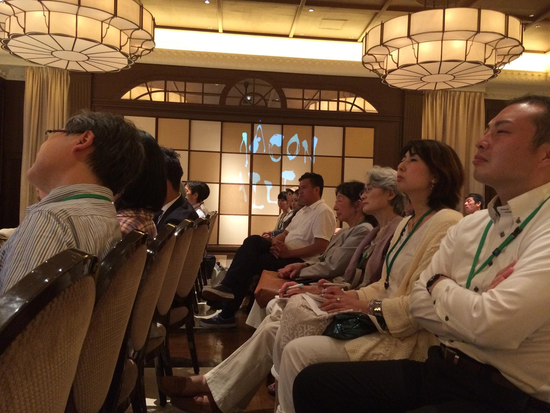 Participants listen to a presentation at Kamakon’s monthly town meeting in June.