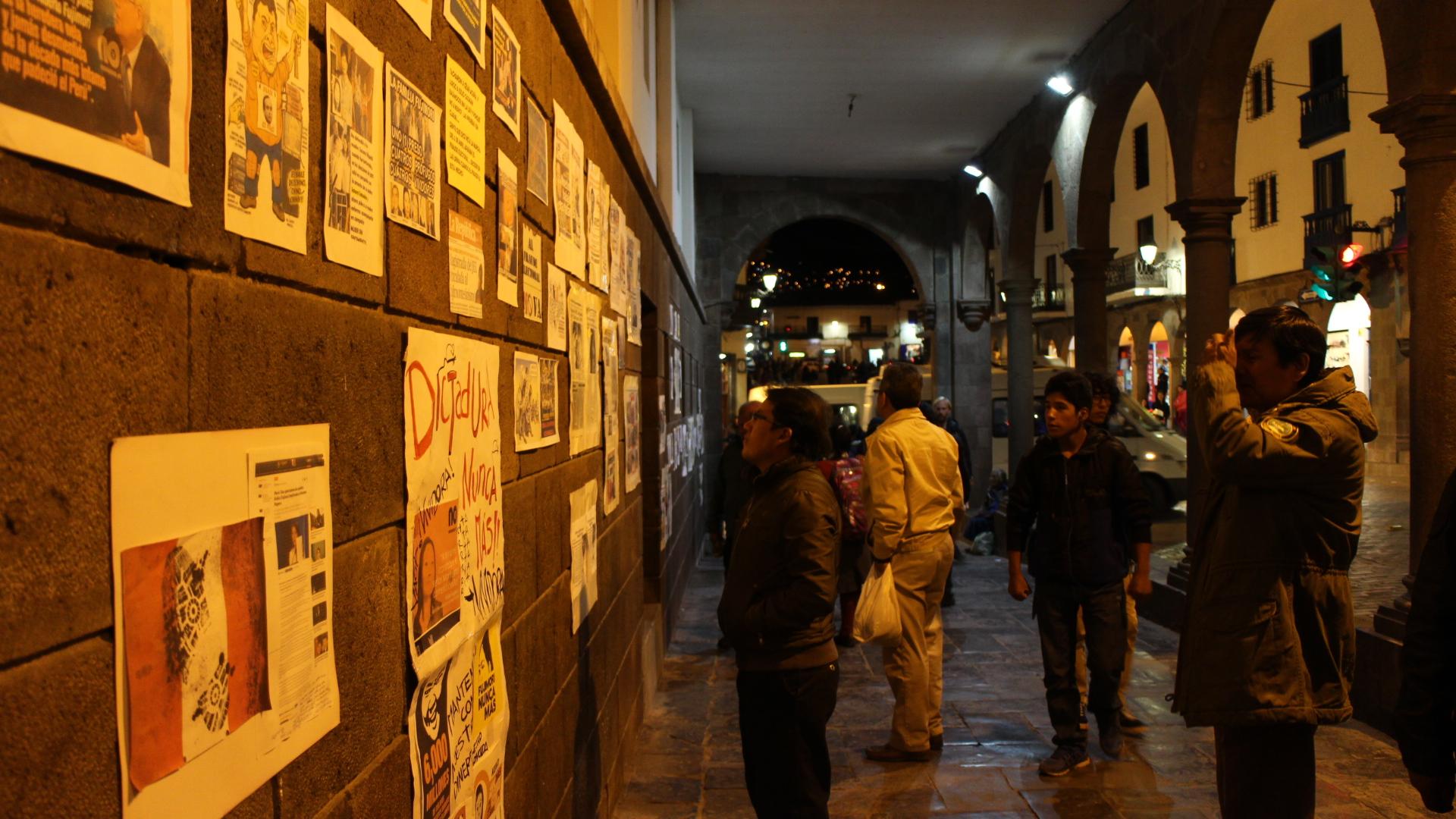 Onlookers read and photograph the wall in downtown Cuzco full of anti-Keiko Fujimori messages.