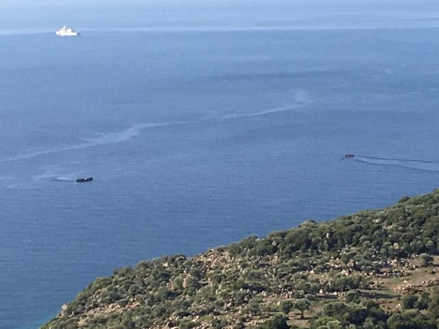 Two boats leaving Assos with the Turkish Coast Guard in the background.