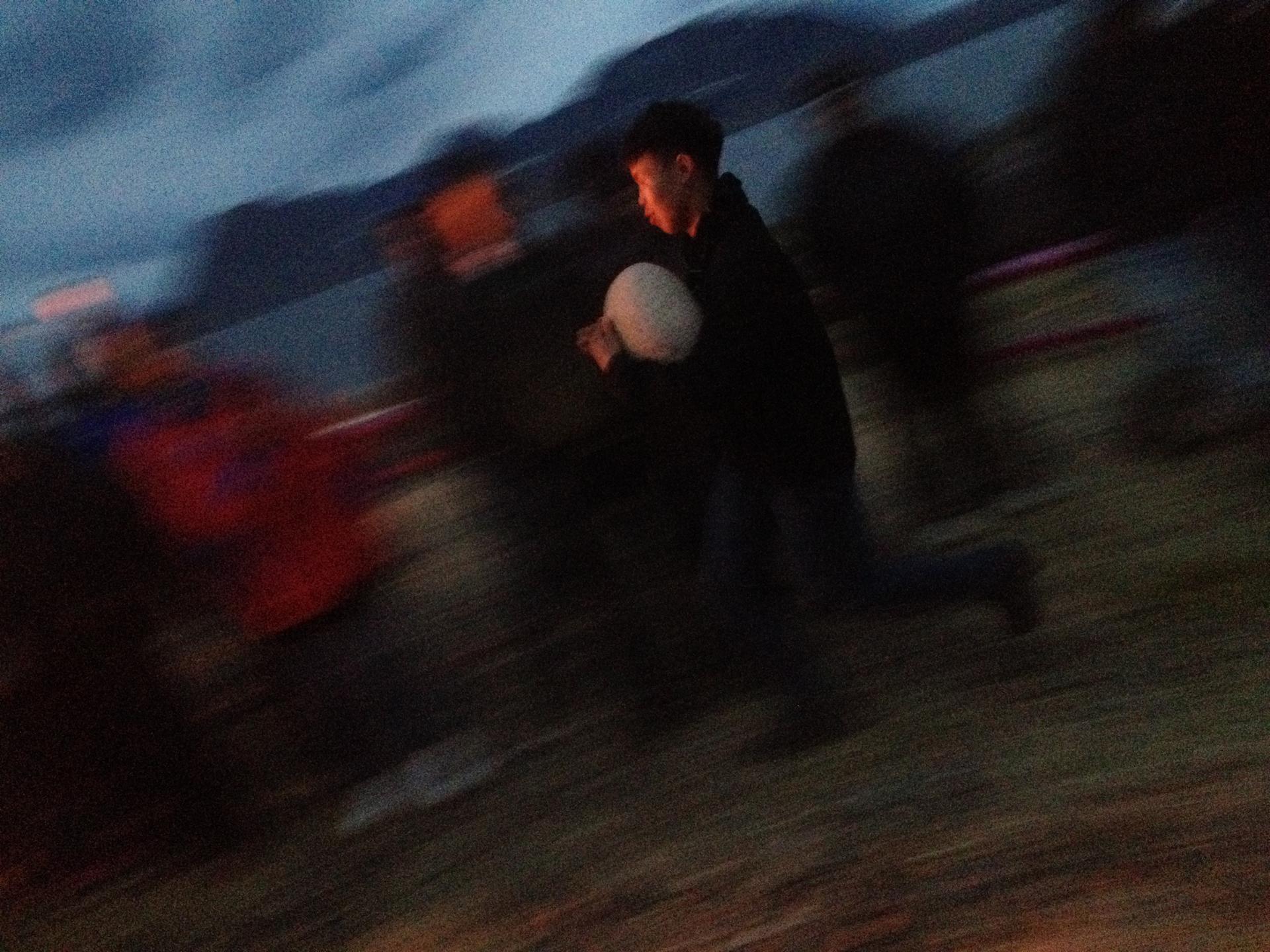 A local boy takes part in the games after dark on the final night of the gathering and celebration.