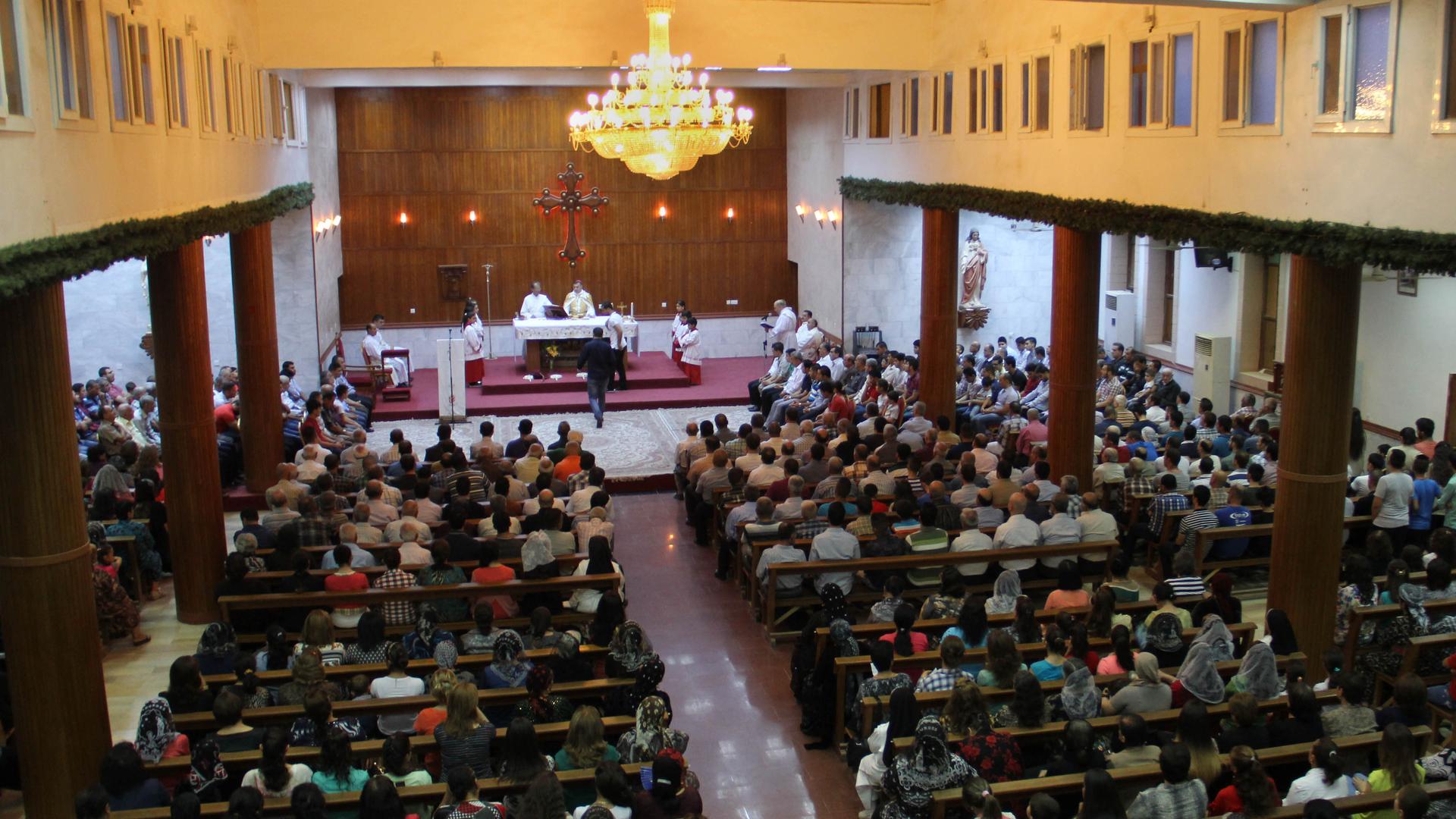 Christians, most displaced from their homes, pray in a church in Erbil in northern Iraq.