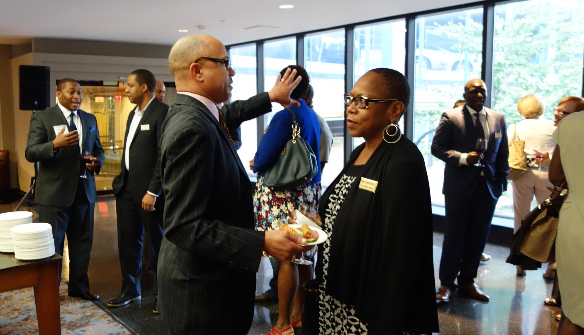 Executives meet at an IT Senior Management Forum gathering, a group that mentors senior African-American managers in STEM fields