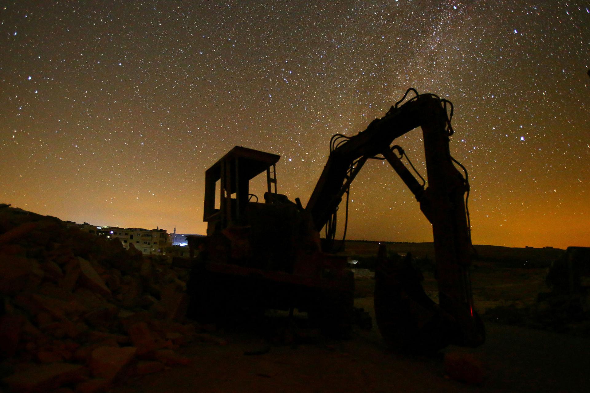 A digger stands amid the rubble in the rebel-controlled area of Maaret al-Numan in Idlib province.