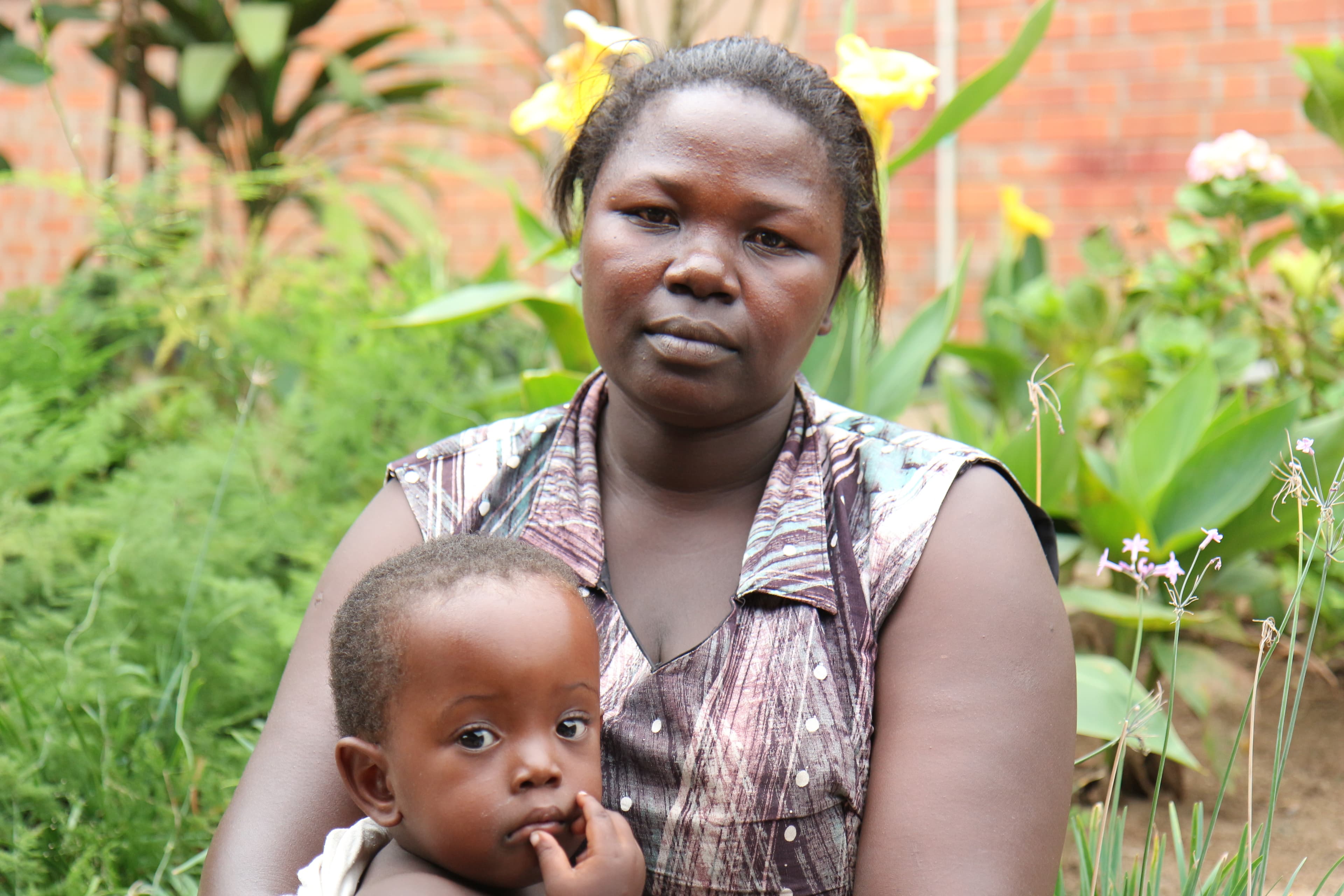 Ayana Beatrice with her daughter Jennifer. Jennifer had the ETV/CPC surgery the year before and now her head size is close to normal.