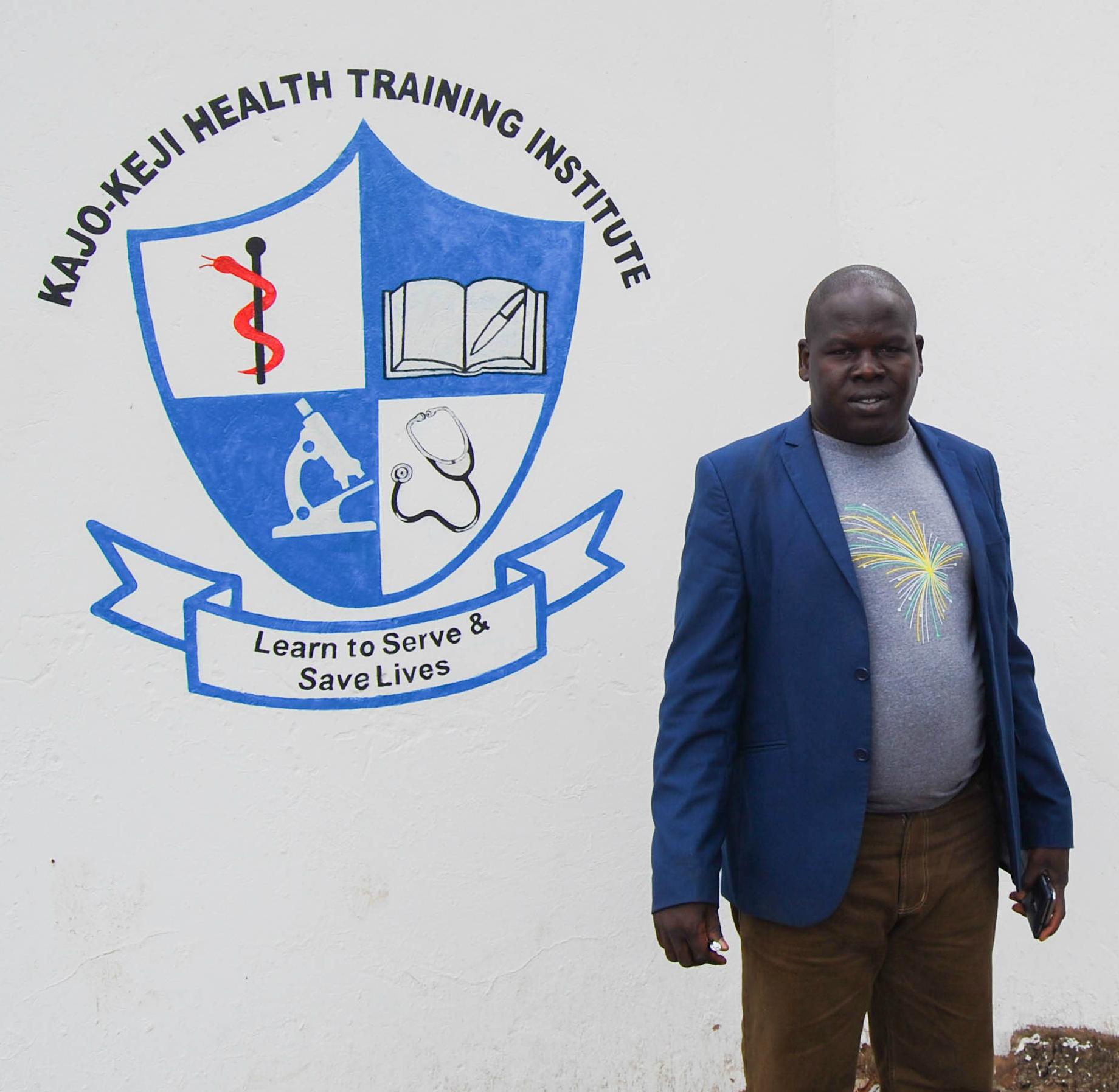 Lou Louis Koboji, the founder and director of the Kajo Keji Health Training Institute, stands outside the school’s new location in Arua, Uganda.