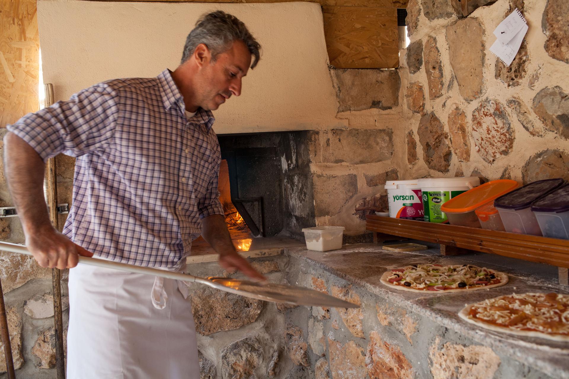 Nail Demir makes pizza in his ancestral village of Kafro in southern Turkey. Pizza isn’t a local delicacy – or at least it wasn’t – until Demir and others returned after decades in Europe.