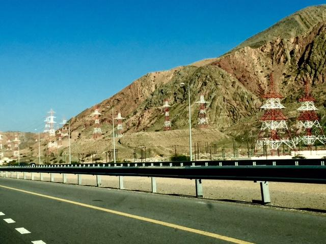 The new wide highways are lined with high-tension wires.