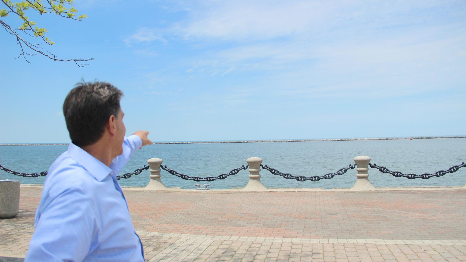 Lorry Wagner, president of LEEDCo points out toward Lake Erie where the world’s first freshwater offshore wind farm, six turbines, will soon be built.