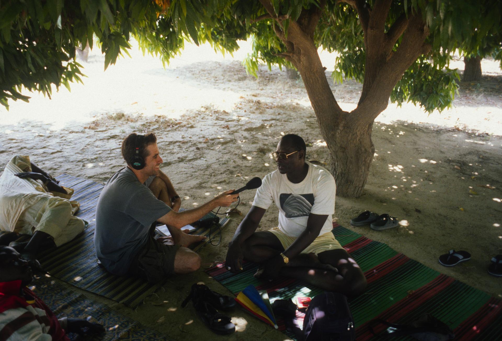 Marco Werman, now host of The World, interviewing singer and musician Ali Farka Toure in Mali in 2000