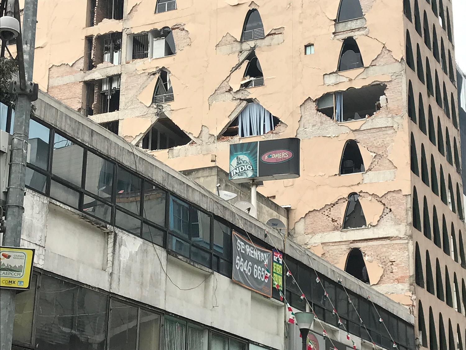 A hotel in Mexico City's Zona Rosa neighborhood lost much of its side wall but did not fall.