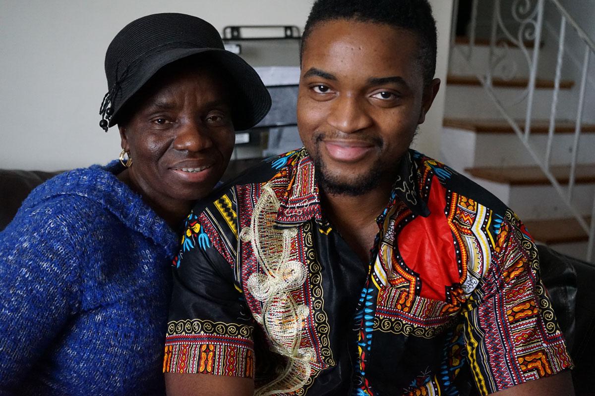 Mercy Krua, and her son Jefferson Krua, on her living room couch in Boston, MA.