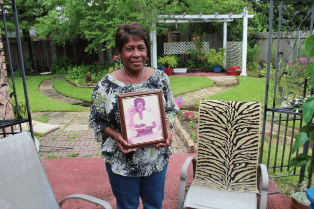 Margie Richard with a photo of her sister Naomi, who died at the age of 43 from a rare bacterial infection. Richard suspected emissions from Shell had something to do with making her sister sick.