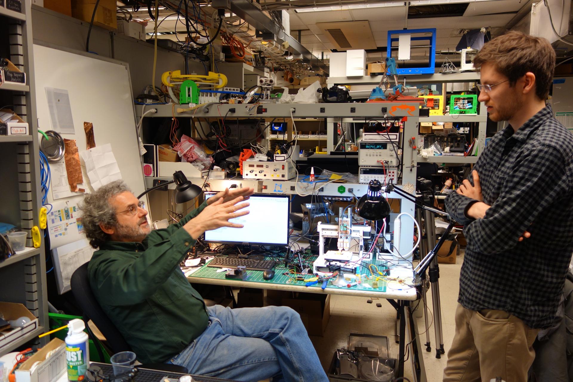 MIT professor Neil Gershenfeld, who directs the Center for Bits and Atoms and oversees the Fab Lab and Fab City movements, talks with PhD student Will Langford